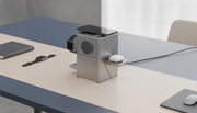 A 3-in-1 magnetic wireless charging station, twisted open to reveal charging pads for a smartphone, smartwatch, and earbuds, 